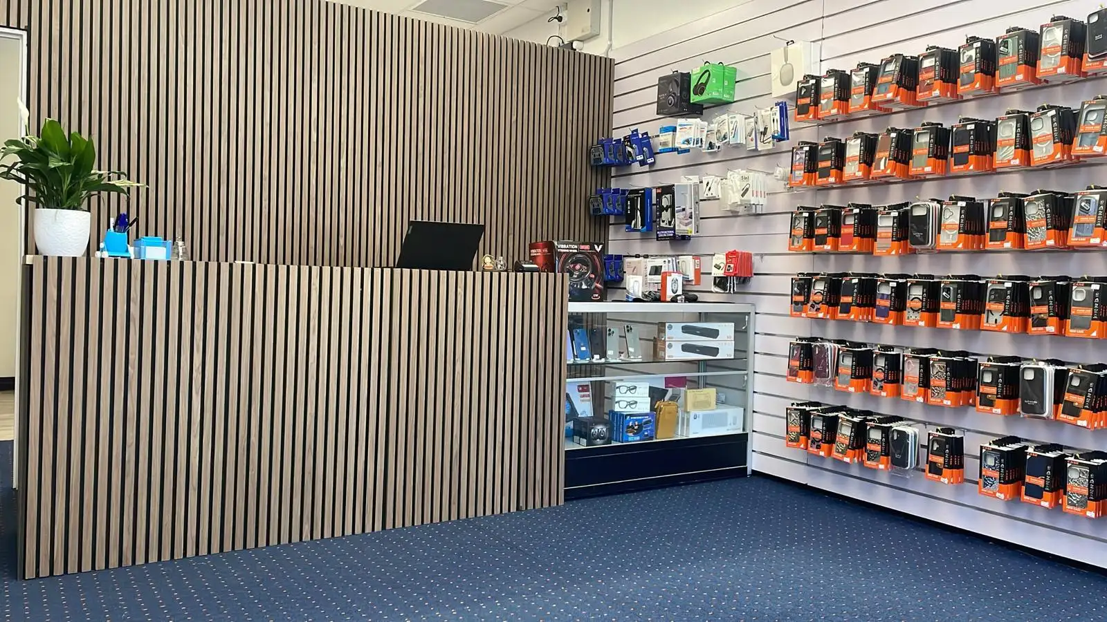 Interior of Gisborne Tech Repair Hub with reception desk and phone accessories